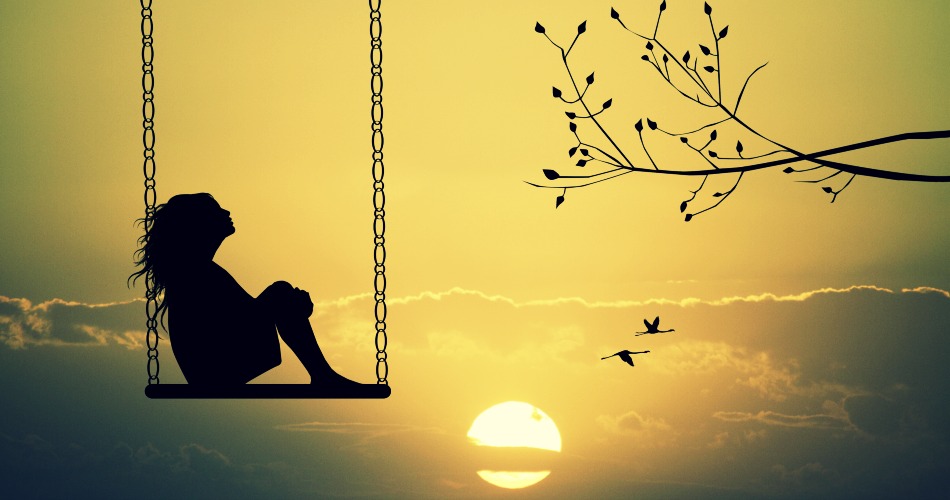 Girl on swing at sunset